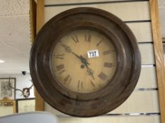 A VINTAGE FRENCH OAK CIRCULAR WALL CLOCK WITH WOODEN DIAL, 38 CMS DIAMETER.
