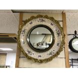 A BURLIEGH WARE CIRCULAR CERAMIC WALL MIRROR WITH FLORAL DECORATION AND ORNATE BRASS BORDE, 48 CMS