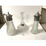 TWO SILVER PLATED EWERS 30CM WITH A SHIPS DECANTER AND A HALLMARKED SILVER DECANTER LABEL (HOBNAIL