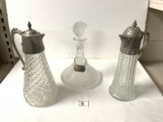 TWO SILVER PLATED EWERS 30CM WITH A SHIPS DECANTER AND A HALLMARKED SILVER DECANTER LABEL (HOBNAIL