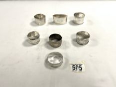 SEVEN HALLMARKED SILVER NAP KIN RINGS, 142 GRAMS.