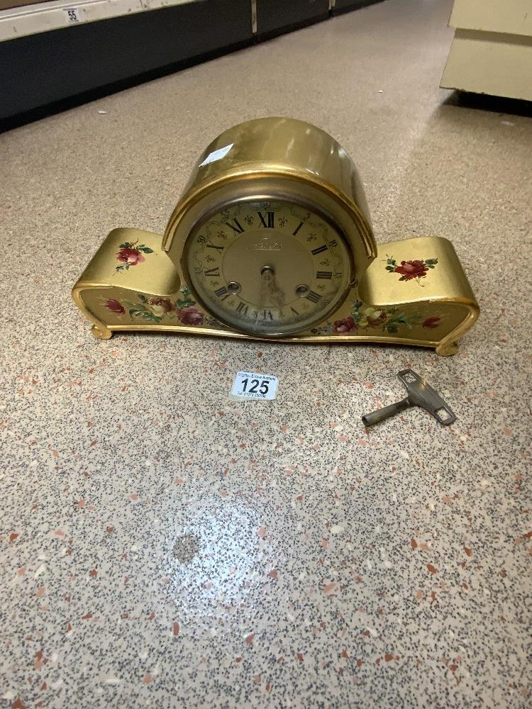 A 1950s GOLD AND FLORAL DECORATED MANTEL CLOCK BY SCHLENKER.