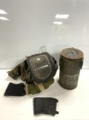 WORLD WAR II BABY GAS MASK, AND A MILITARY TIN DATED 1952.