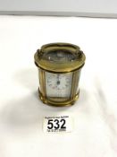 SMALL BRASS OVAL CARRIAGE CLOCK WITH WHITE ENAMEL DIAL, MAKER FORUM, 8 CMS.