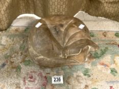 CARVED WOODEN FIGURE OF A SLEEPING CAT.