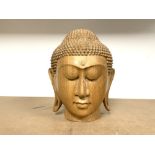 A CARVED WOODEN THAI HEAD, 25 CMS.