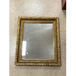 ORNATE EMBOSSED GILT FRAMED WALL MIRROR, 66X76 CMS.