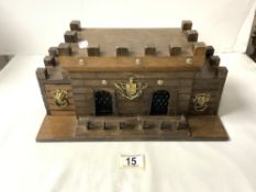 A CARVED WOODEN CASTLE FORM TWO BOTTLE AND 4 GLASSES LIQUOR SET.