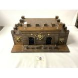 A CARVED WOODEN CASTLE FORM TWO BOTTLE AND 4 GLASSES LIQUOR SET.