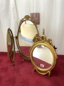 A GILT PAINTED PLASTER OVAL WALL MIRROR WITH RIBBON DECORATION, 30X47 CMS.