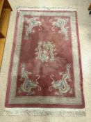 CHINESE PINK GROUND AND DRAGON PATTERN RUG, 122 X 82 CM.
