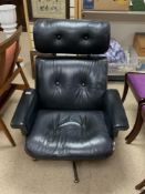 EAMES DESIGN BLACK LEATHER AND WALNUT PLY BACK SWIVEL LOUNGE CHAIR.