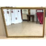 LARGE WALL MOUNT BEVELLED MIRROR IN A GILDED FRAME. 150 X 119CMS.