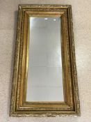 LARGE ORNATE EMBOSSED GILT FRAMED RECTANGULAR WALL MIRROR, 164X80 CMS. A/F.