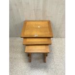 A NEST OF THREE MID CENTURY TEAK WOOD PARKER KNOLL TABLES.