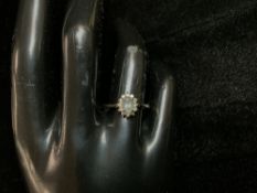 9CT GOLD RING WITH A CENTRAL AQUAMARINE SURROUNDED WITH DIAMONDS SIZE O.5