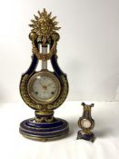 A BLUE AND GILT PORCELAIN MARIE ANTOINETTE CLOCK WITH A GERMAN FRANZ HERMAN MADE MOVEMENT; 38 CMS