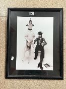 A FRAMED PHOTOGRAPH OF DAVID BOWIE AND LEAPING DOG.