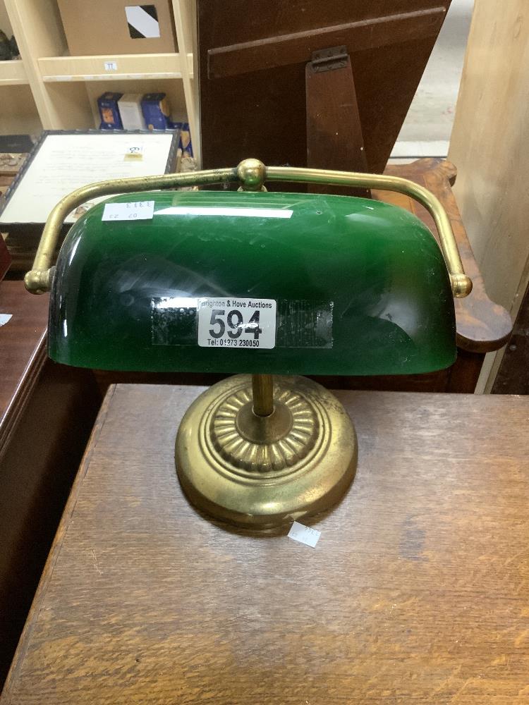 A BRASS AND GREEN GLASS SHADE DESK LAMP.