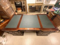 A REPRODUCTION MAHOGANY INVERTED BREAKFRONT PARTNERS PEDESTAL DESK WITH REEDED CORNER DETAIL; 180X90