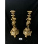PAIR OF REGENCY DESIGN GILT METAL CANDLESTICKS WITH PUTTI SUPPORTS; 31 CMS.