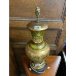 A GREEN AND GILT DECORATED CERAMIC TABLE LAMP; 52 CMS.