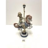 A LLADRO PORCELAIN FIGURE OF A GIRL ON A CAROUSEL HORSE A/F.