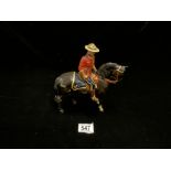 A BESWICK PORCELAIN FIGURE OF A CANADIAN MOUNTIE {A/F}