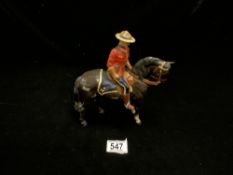 A BESWICK PORCELAIN FIGURE OF A CANADIAN MOUNTIE {A/F}