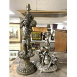 A GOLD PAINTED PUTTI FIGURE TABLE LAMP; 48 CMS AND A SILVER PAINTED FIGURE TABLE LAMP.