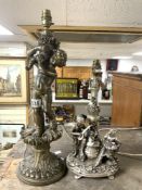 A GOLD PAINTED PUTTI FIGURE TABLE LAMP; 48 CMS AND A SILVER PAINTED FIGURE TABLE LAMP.