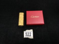 A CARTIER GOLD PLATED POCKET LIGHTER IN BOX.