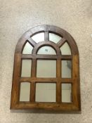 A HARDWOOD FRAMED ARCHED SECTIONAL MIRROR; 60X8O CMS.