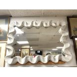 A MODERN PAINTED SCALLOP SHAPED FRAMED WALL MIRROR; 102X72 CMS.