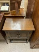 A SMALL OAK TWO DOOR CUPBOARD; 60X34X74 CMS.