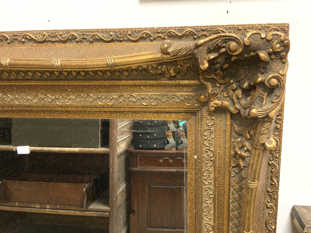 A LARGE MODERN ORNATE GILT FRAMED WALL MIRROR; 158X130 CMS. - Image 2 of 3