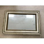 ANTIQUE MIRROR PLATE IN A CREAM AND GILT PAINTED FRAME; 122X82 CMS.