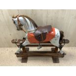 A VINTAGE PAINTED WOODEN ROCKING HORSE, 108X96.