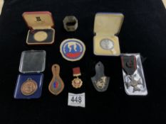 MIXED ITEMS INCLUDE A MILITARY COIN, MEDALLIONS, HALLMARKED SILVER NAPKIN RING, CLOTH BADGES AND