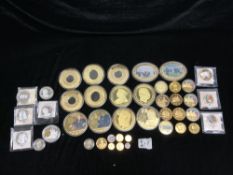 FOUR SILVER PROOF COMMEMORATIVE COINS AND QUANTITY OF GOLD-PLATED NICKEL COMMEMORATIVE COINS.