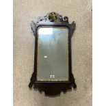 A REGENCY MAHOGANY AND GILT PHEONIX DECORATED FRETWORK WALL MIRROR; 48X90 CMS.