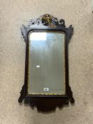 A REGENCY MAHOGANY AND GILT PHEONIX DECORATED FRETWORK WALL MIRROR; 48X90 CMS.