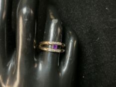 A 9K MARKED GOLD DRESS RING WITH PURPLE STONE SET RING; 2.9 GMS.