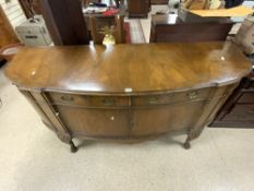 A 1930s WALNUT SHAPED BOW FRONTED SIDEBOARD ON CARVED CABRIOLE LEGS AND BRASS SWAN NECK HANDLES;