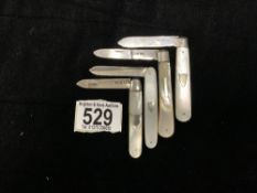 FOUR HALLMARKED SILVER AND MOTHER O PEARL FRUIT KNIVES.