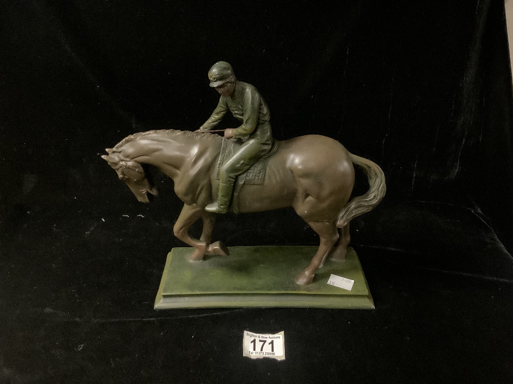 A BRONZED RESIN FIGURE OF A HORSE AND JOCKEY; 28X36 CMS.