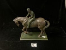 A BRONZED RESIN FIGURE OF A HORSE AND JOCKEY; 28X36 CMS.