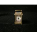 MINIATURE FRENCH CLOCK WITH HAND PAINTED ENAMEL IN BRASS CASING; 8CM