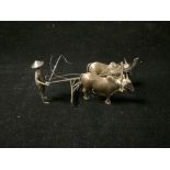 ORIENTAL WHITE METAL FIGURE OF FARMER AND OX PLOUGHING.