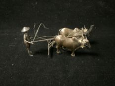 ORIENTAL WHITE METAL FIGURE OF FARMER AND OX PLOUGHING.